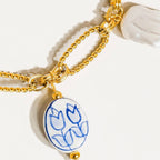 Blue and pearl charm necklace